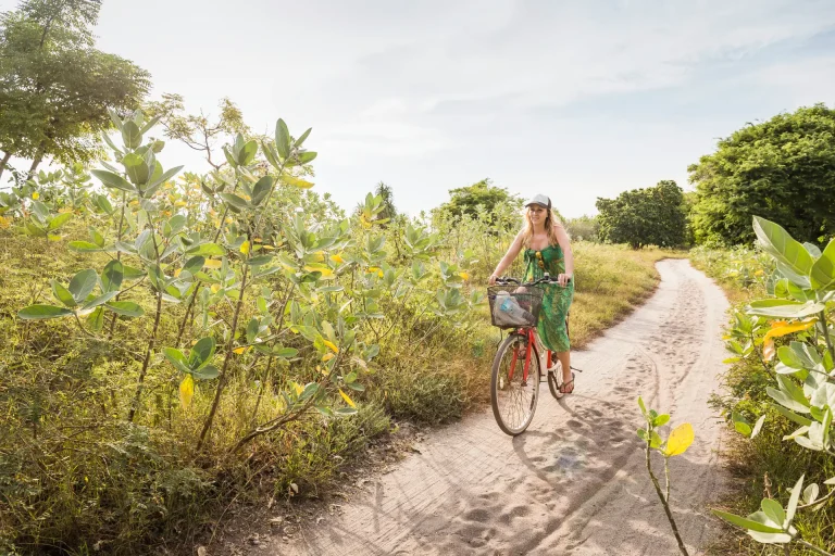 young woman riding a bike on a path